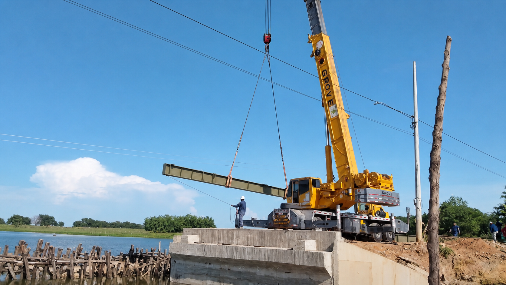 Montaje de un puente metálico con apoyo de una grúa.